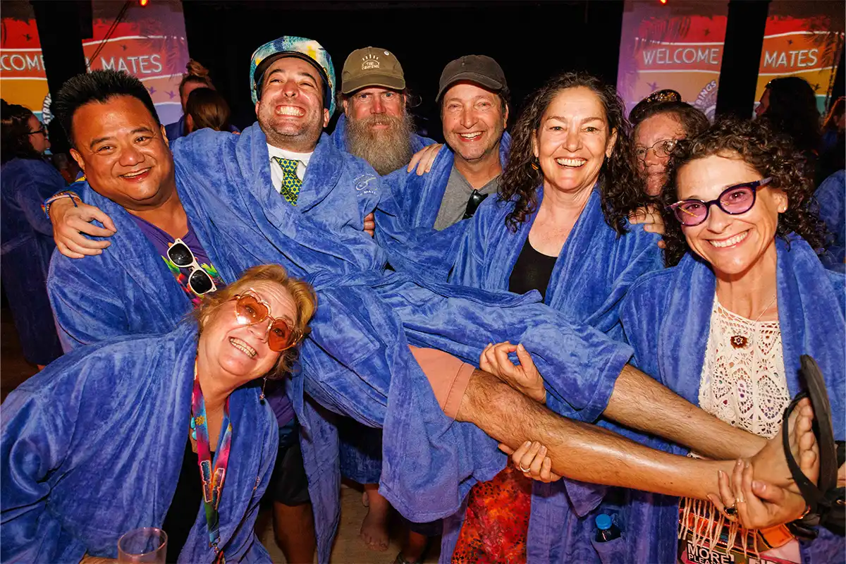 Guests wearing blue loyalty program robes posing together