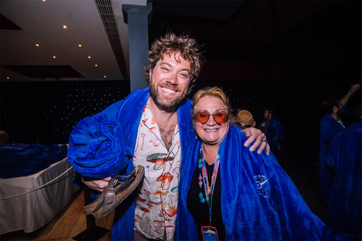 Guests wearing blue loyalty program robes posing together