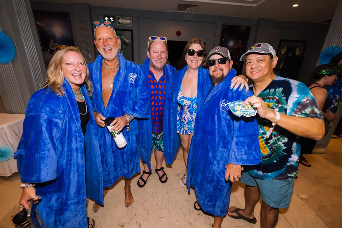Guests wearing blue loyalty program robes posing together