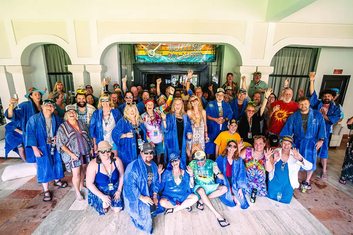 Group photo of guests wearing blue loyalty program robes