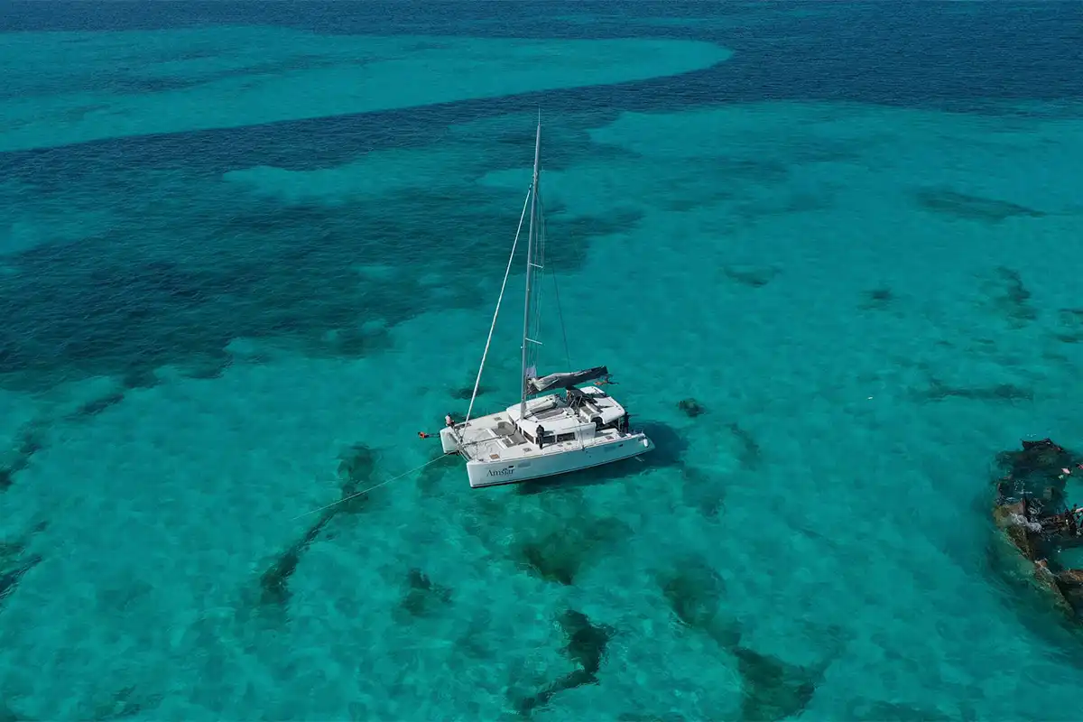 Aerial view of a catamaran over a reef.