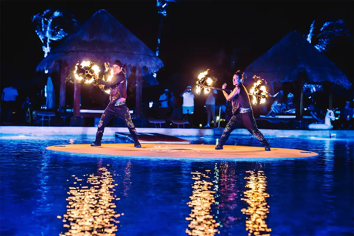 Fire dancers performing a show by the main pool.