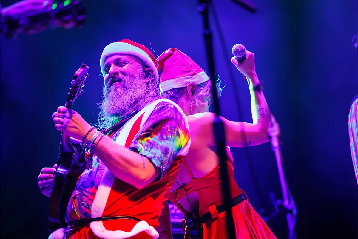 Artists in theme night costume on stage performing.