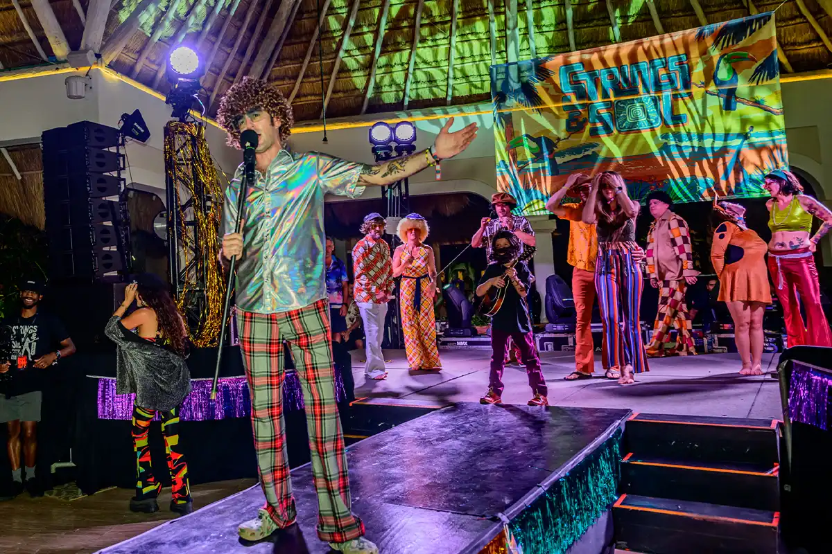 Guests in costumes on stage during theme night contest.