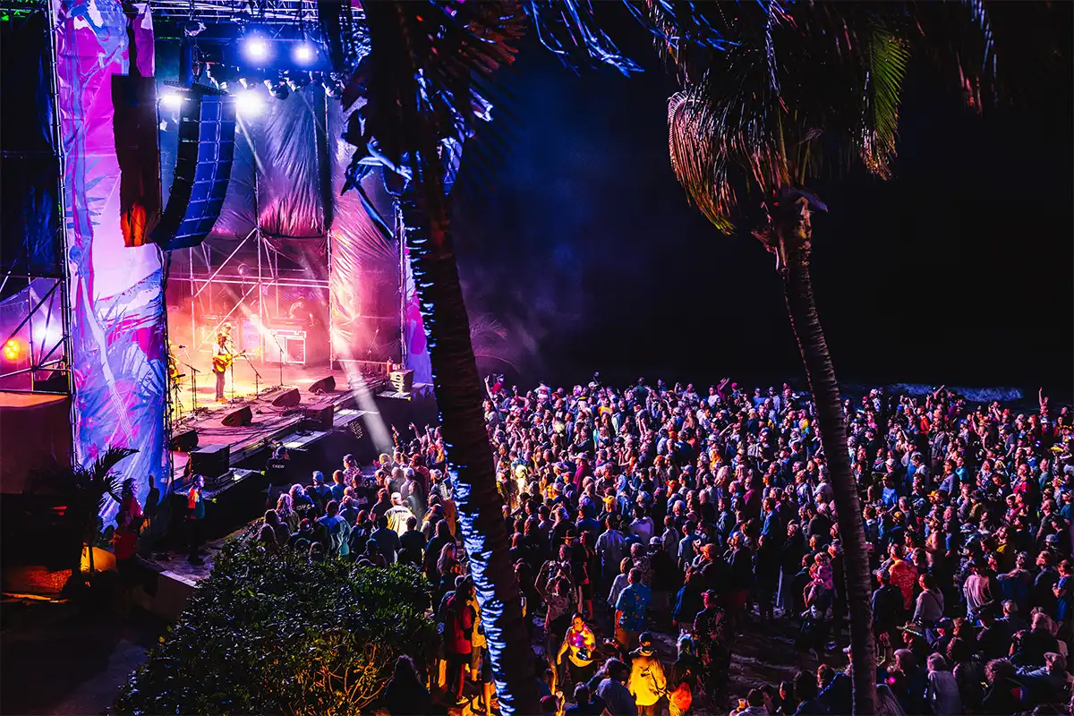Nighttime Beach Stage crowd view from an Oceanfront Suite balcony.
