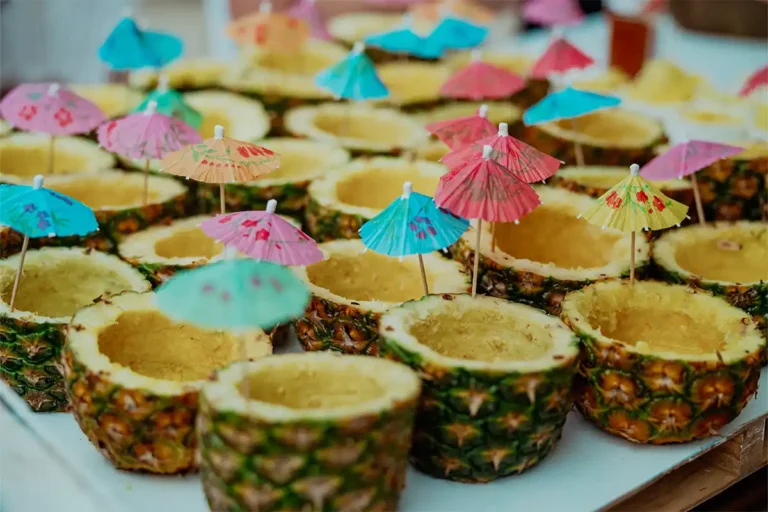 A tray of sliced pineapple drinks.