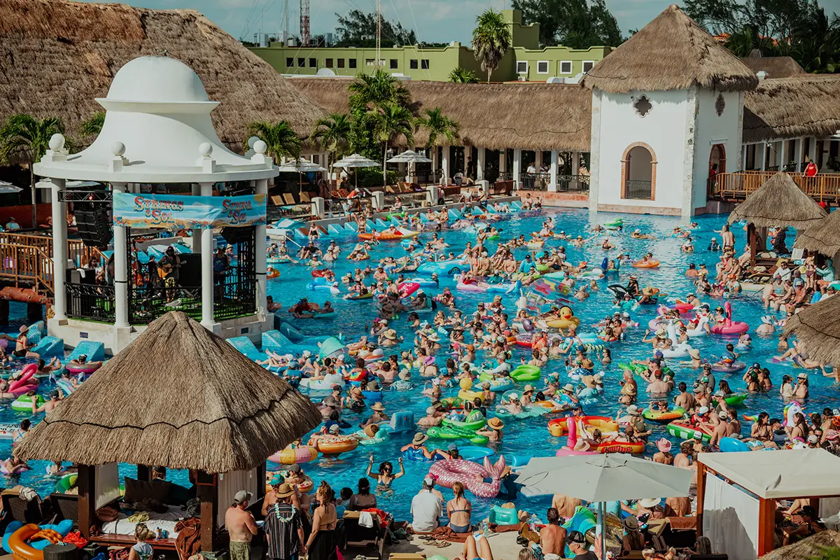 Overhead view of pool gazebo stage surrounded by guests floating in the pool